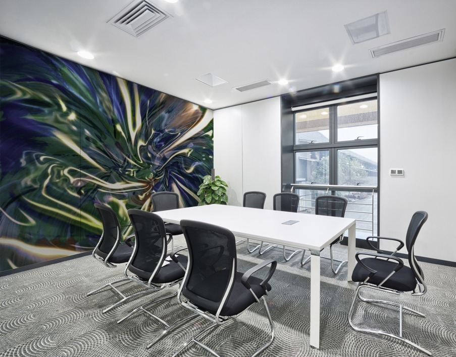 meeting room with blue mural print on the wall with fluid pattern strips of light